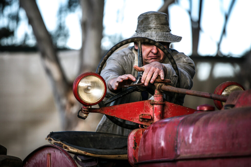Agricultural photography: Farming portrait photo of man on tractor